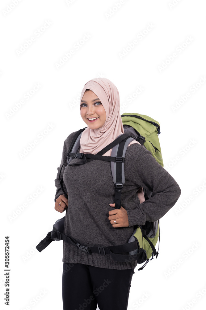 Portrait of beautiful hijab traveller with backpack smile looking at camera with isolated background
