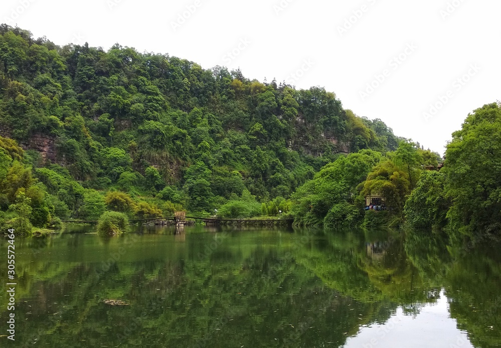 a beatiful lake with green trees and reflection in the water