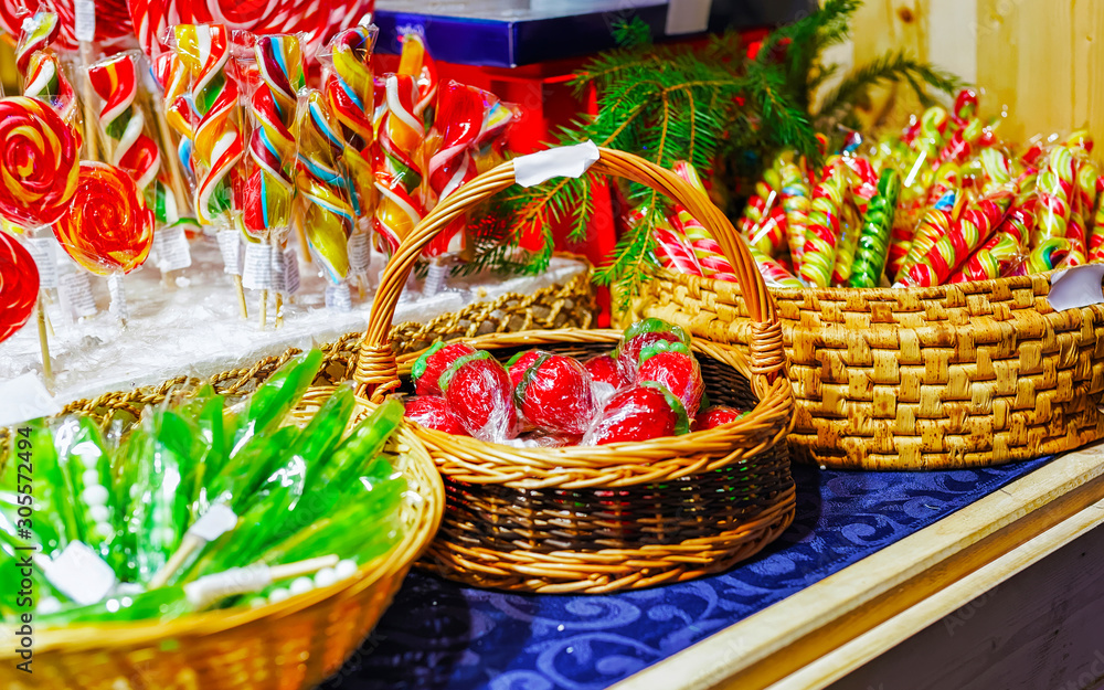 Lollipop candies in Christmas market in Lithuania Europe in winter. Sweet food at Lithuanian Night street Xmas and holiday fair European city or town, December. Vilnius