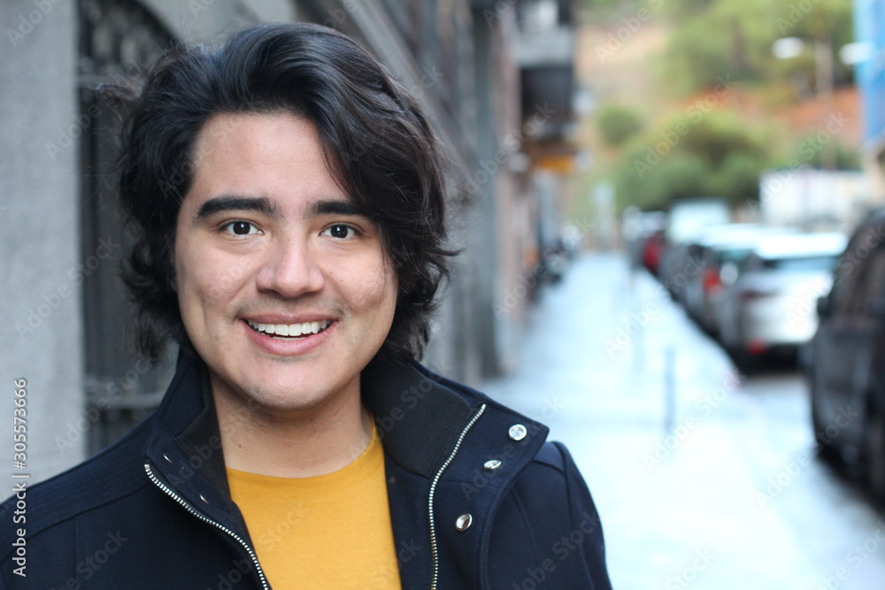 Young Hispanic man smiling outdoors 