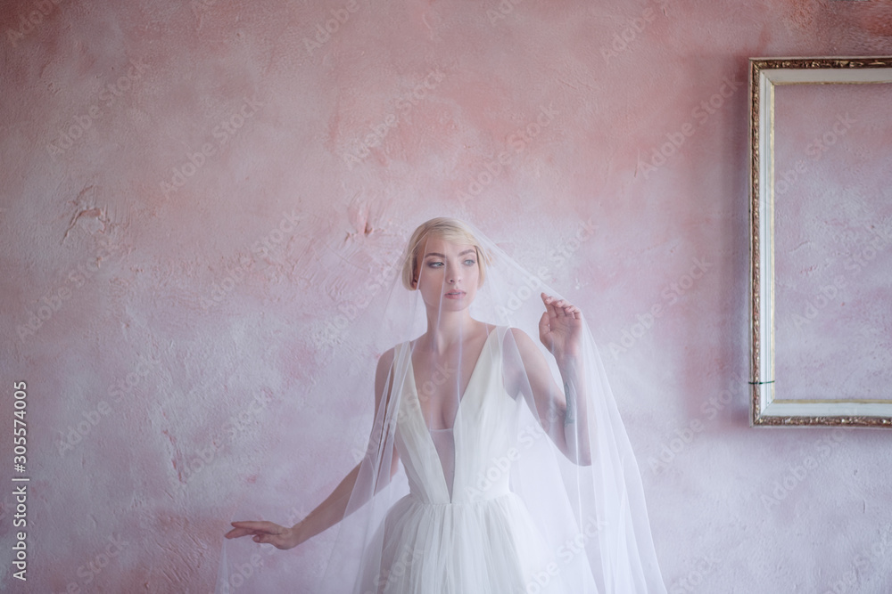 Beautiful and courageous bride with an unusual beech and veil. Portrait of a beautiful bride with short hair. Beautiful and courageous bride with an unusual beech and veil. Portrait of a beautiful bride with short hair.