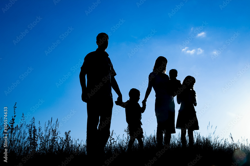happy family outdoors in the park silhouette