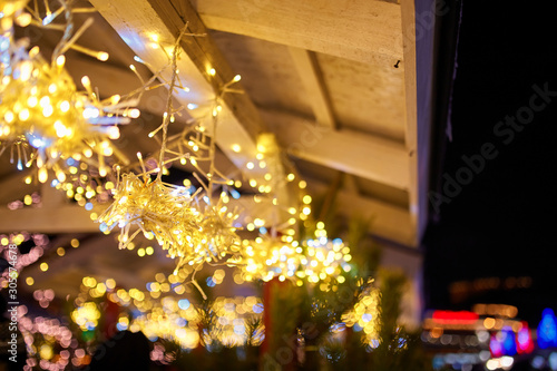 Christmas decorations on the street  colorful holiday bokeh lights  city night illumination