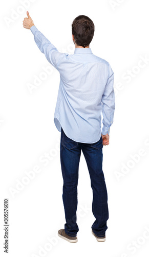Back view of a man showing thumb up.