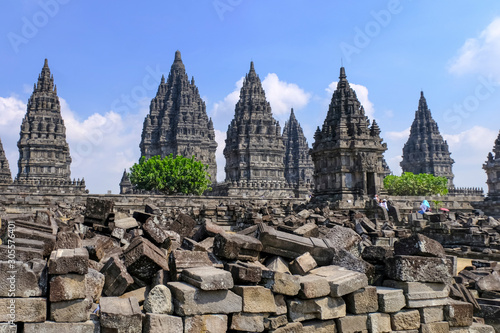 Konstfotografi Pagodas and tourist in Prabanan Temple or Candi Prambanan against blue sky with