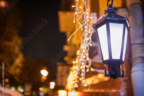 New Year festoon illumination on city alley photo