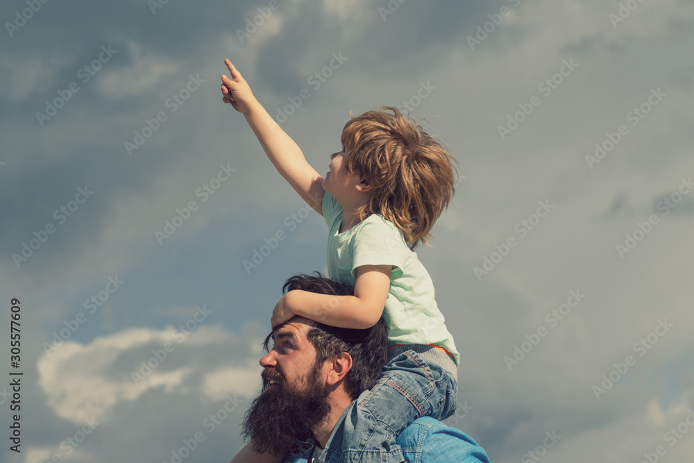 Family holiday and togetherness. Father and son together. Daddy and son smiling and hugging Family holiday and togetherness. Father and son together. Daddy and son smiling and hugging