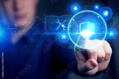 Cyber security data protection business technology privacy concept. Young businessman working  in the office  select the icon security on the virtual display.