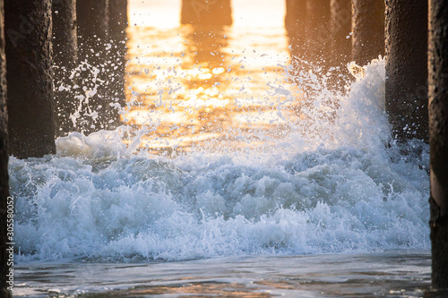 Wallpaper Mural Waves crashing under the pier at sunrise Torontodigital.ca