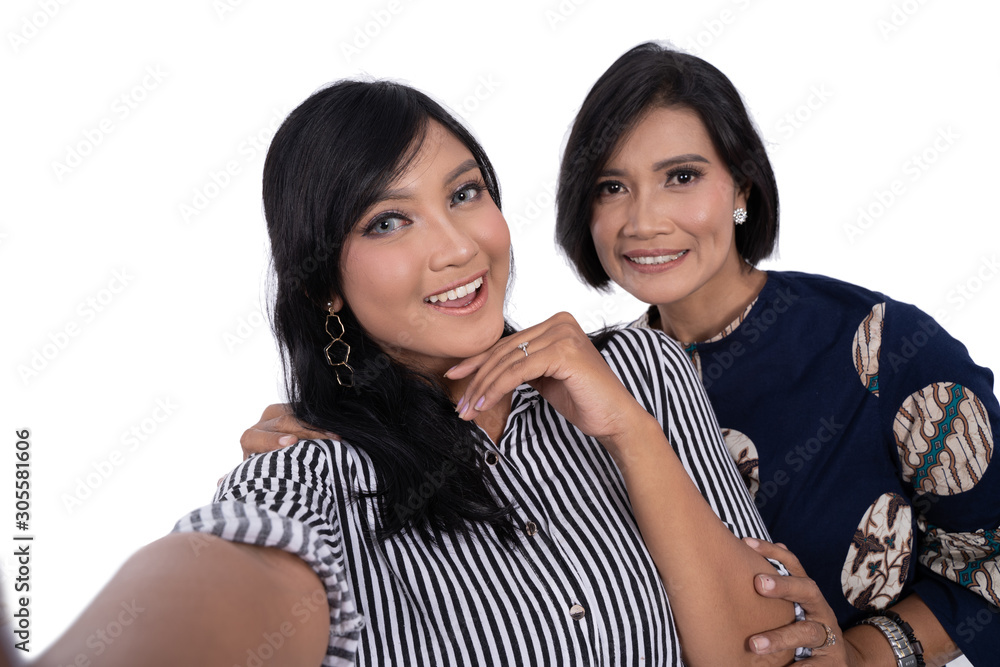 selfie together of happy young beautiful women with her mother at isolated background selfie together of happy young beautiful women with her mother at isolated background