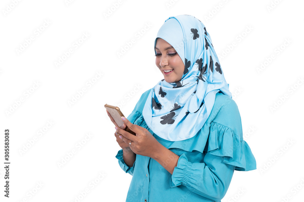 Asian veiled woman using smartphone at isolated background Asian veiled woman using smartphone at isolated background