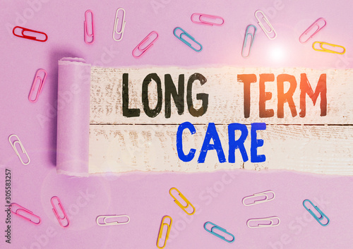 Handwriting text Long Term Care. Conceptual photo Adult medical nursing Healthcare Elderly Retirement housing Paper clip and torn cardboard placed above a wooden classic table backdrop photo