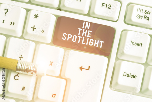 Handwriting text writing In The Spotlight. Conceptual photo when crowd concentrating with individual demonstrating White pc keyboard with empty note paper above white background key copy space