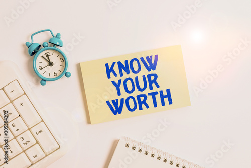 Conceptual hand writing showing Know Your Worth. Concept meaning Have knowledge of selfvalue Worthiness Deserved income Keyboard with empty note paper and pencil white background photo