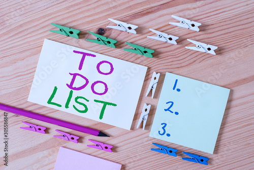 Text sign showing To Do List. Business photo showcasing A structure that usualy made in paper contining task of yours Colored clothespin papers empty reminder wooden floor background office