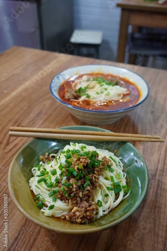 Sichuan style spicy noodles with pork intestines and Zhajiang mian(soybean paste noodle) as breakfast. photo