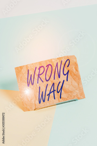 Word writing text Wrong Way. Business photo showcasing taking an unsuitable or undesirable analysisners or direction Paper placed tilted above buffer wire on soft pastel multi colours backdrop photo