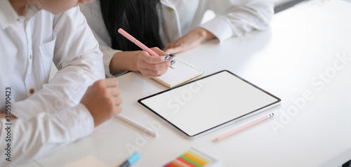 Obraz na plátně Cropped shot of young hard-working designer working on their concepts together w