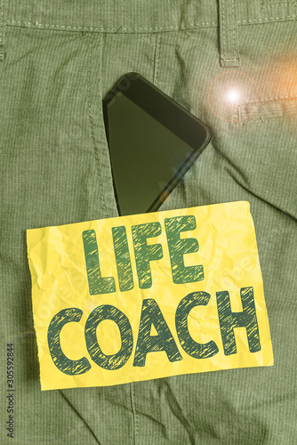 Writing note showing Life Coach. Business concept for someone who helps identify your goals and plan to achieve them Smartphone device inside trousers front pocket note paper photo