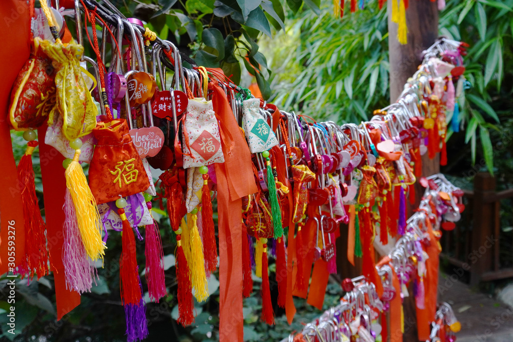 Wishes tree on market place full of tourists on Jinli ancient street in Chengdu city downtown in Sichuan. Translation is 