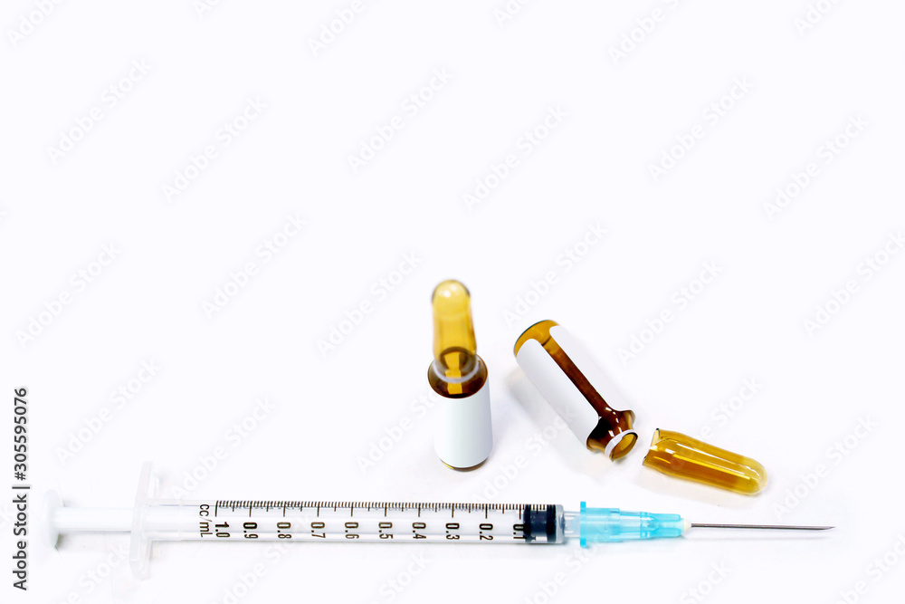 3 ml. brown ampules of drug is opened and plastic syringes with medical needle on white background. 3 ml. brown ampules of drug is opened and plastic syringes with medical needle on white background.