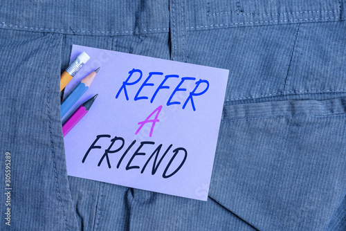 Writing note showing Refer A Friend. Business concept for Recommendation Appoint someone qualified for the task Writing equipment and purple note paper inside pocket of trousers