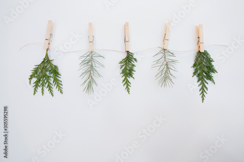 Evergreen foliage close pinned to a white and gold string
