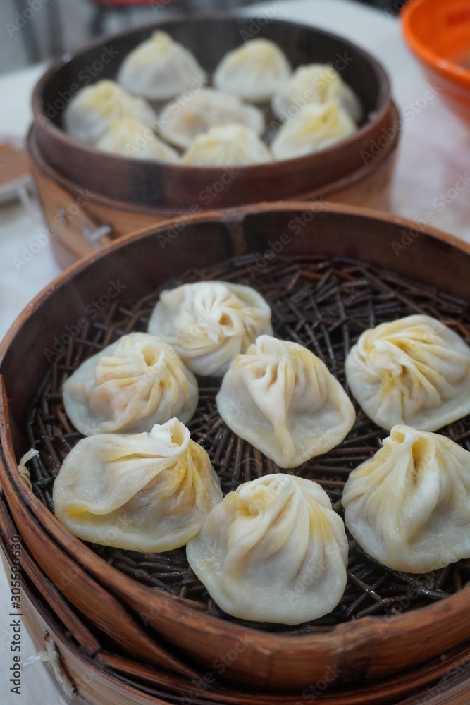 Delicious xiao long tang bao (Shanghai steamed soup dumplings). The broth-filled Shanghainese steamed pork dumplings is an iconic chinese dish in Shanghai. Delicious xiao long tang bao (Shanghai steamed soup dumplings). The broth-filled Shanghainese steamed pork dumplings is an iconic chinese dish in Shanghai.