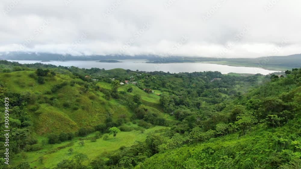 Aerial of rainforest jungle with beautiful Lake Arenal, unspoiled green forest and lush mountainous scenery Aerial of rainforest jungle with beautiful Lake Arenal, unspoiled green forest and lush mountainous scenery