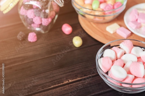 multi-colored candies in a plate, bank and bowls with copy space