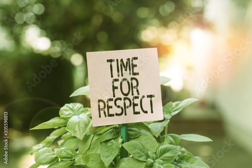 Text sign showing Time For Respect. Business photo showcasing when you asking everyone to watch their altitude with you Plain empty paper attached to a stick and placed in the green leafy plants © Artur