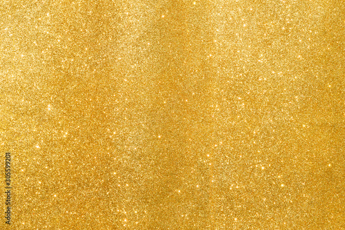 shine and sparkle of golden glitter abstract background 