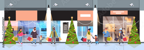 people walking with colorful paper bags merry christmas happy new year shopping concept mix race parents with children holding purchases modern mall exterior horizontal banner full length vector