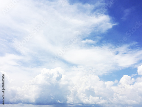 white fluffy clouds on blue sky in summer on sunny day © tassita