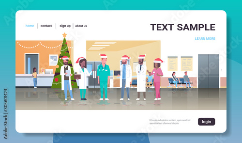 mix race doctors team in santa hats standing together medicine healthcare concept christmas new year holidays celebration modern hospital corridor interior full length flat horizontal copy space