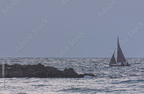 Seascape with sailing boat at dusk as background