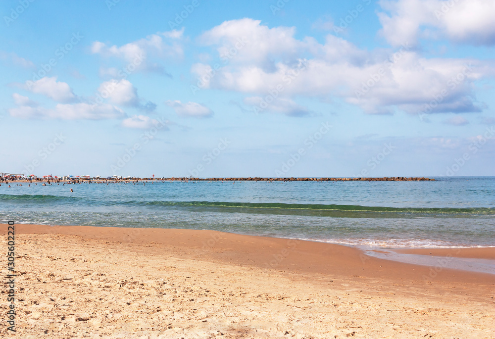 View of the city beach with a breakwater on the horizon View of the city beach with a breakwater on the horizon