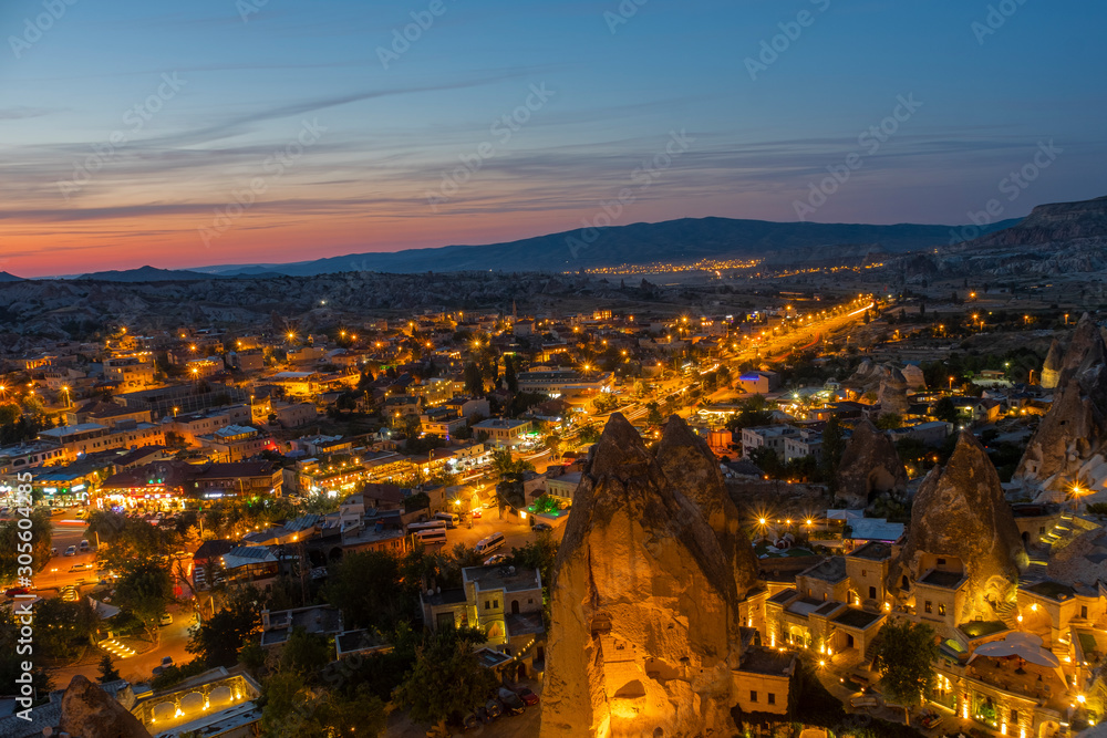 Cappadocia Panoramic nightscape during twilight of Goreme city center, located among the fairy chimney or rock formations in Nevşehir province, Turkey