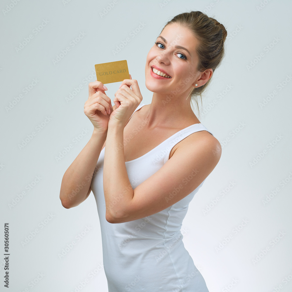 Smiling woman in white strap vest holding credit card. Smiling woman in white strap vest holding credit card.