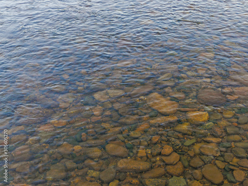 stones pebbles under water in autumn