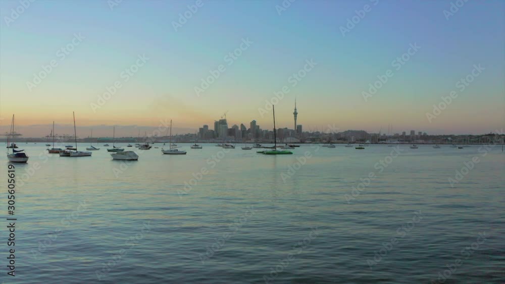 Flight towards yachts, boats in Auckland harbour at sunset, aerial shot Flight towards yachts, boats in Auckland harbour at sunset, aerial shot