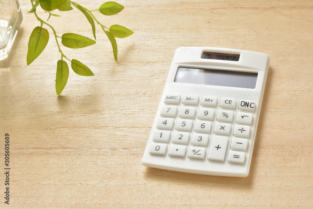 Calculator on a wooden table Calculator on a wooden table