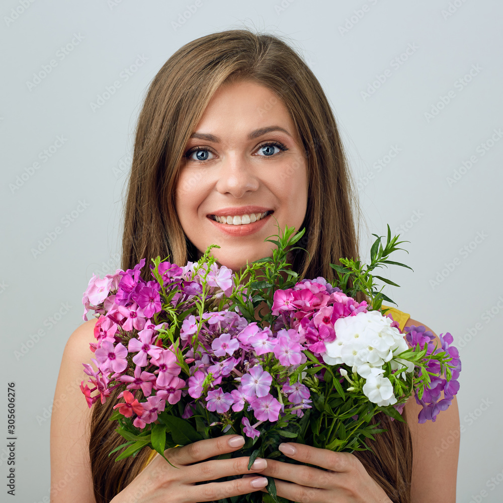 face portrait of smiling woman holding flowers. face portrait of smiling woman holding flowers.