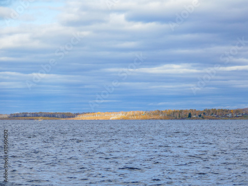 a large reservoir in the autumn cloudy sky and hill
