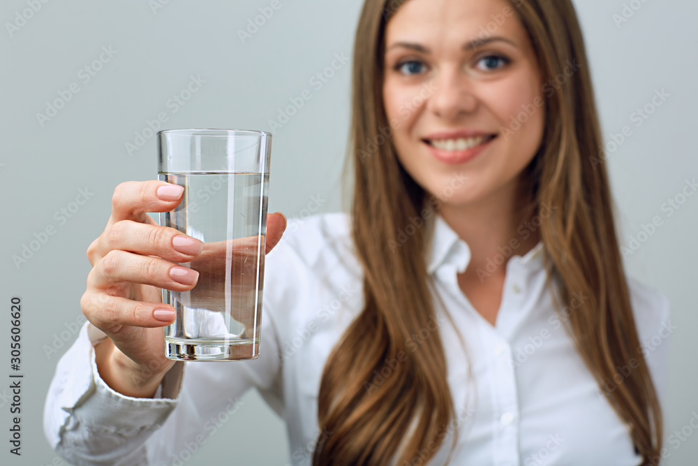 Young woman in white shirt holding water glass. Young woman in white shirt holding water glass.