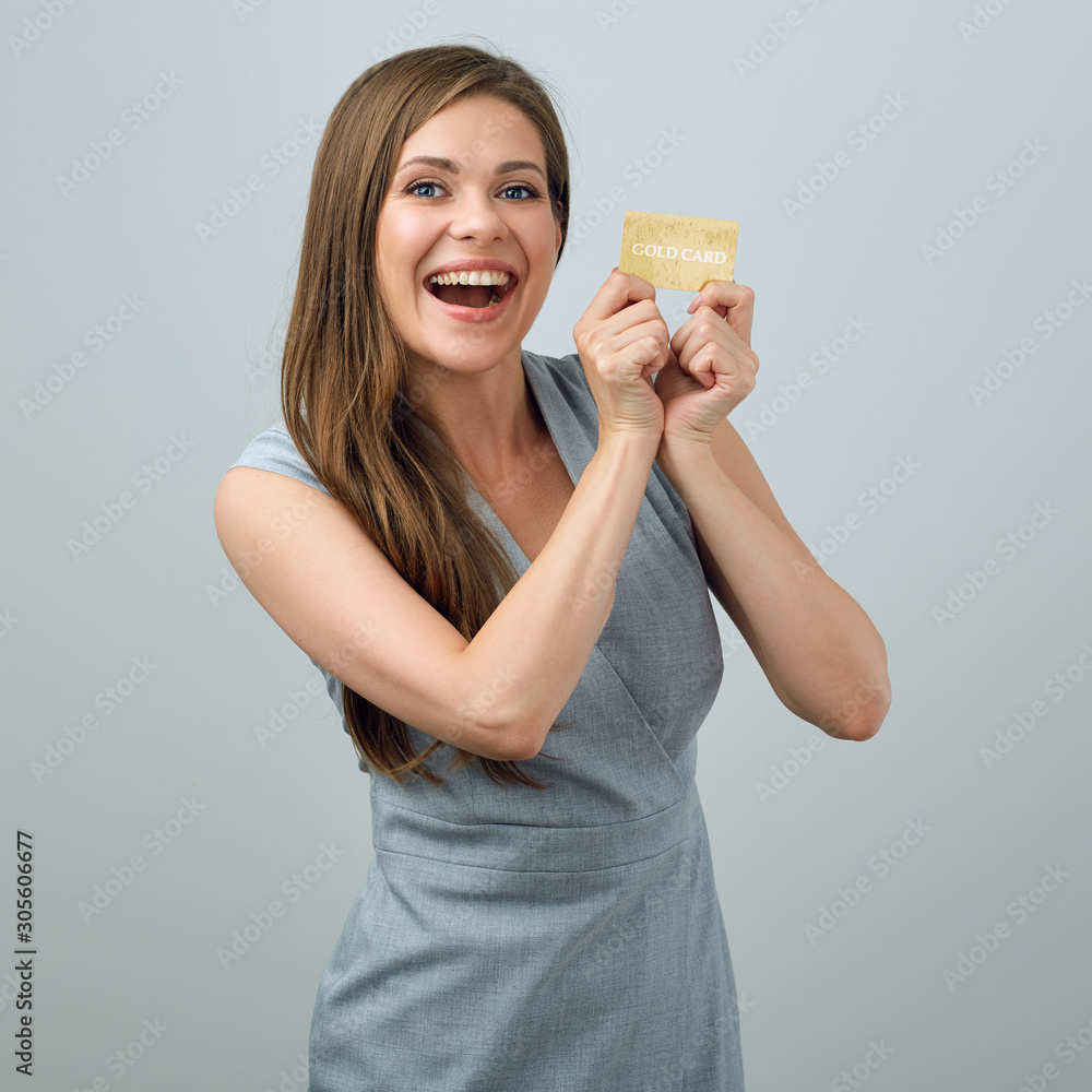 happy young woman wearing business dress holding credit card. happy young woman wearing business dress holding credit card.
