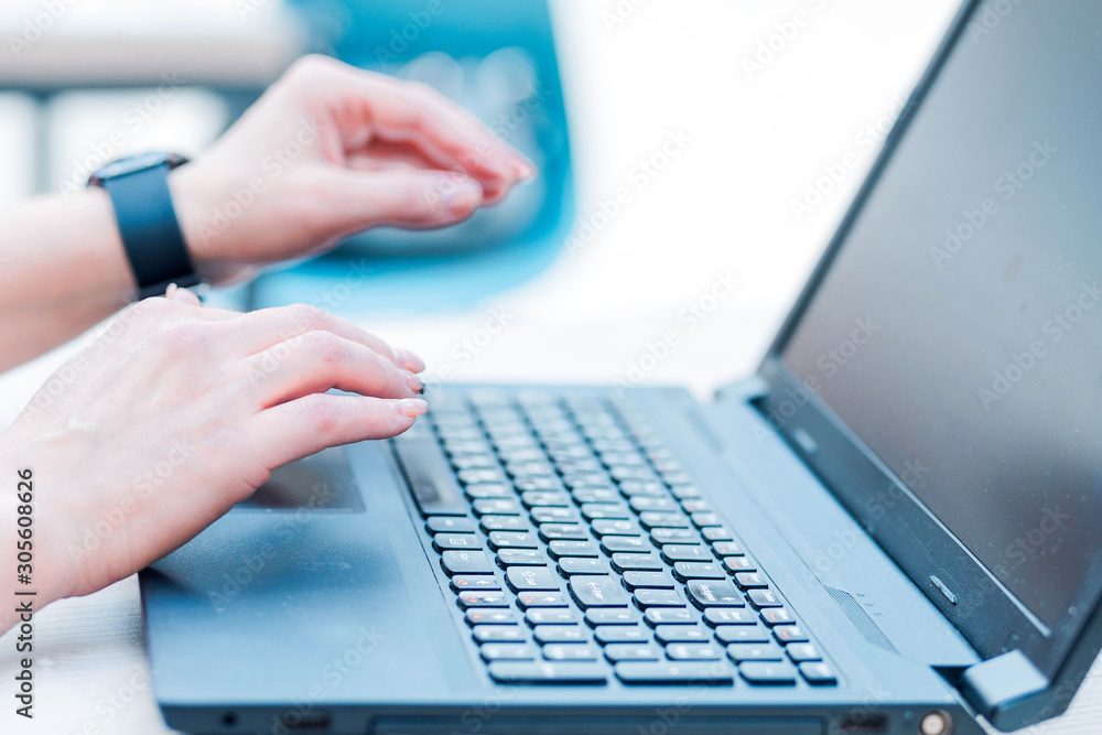 Female hands almost touch laptop keyboard Female hands almost touch laptop keyboard
