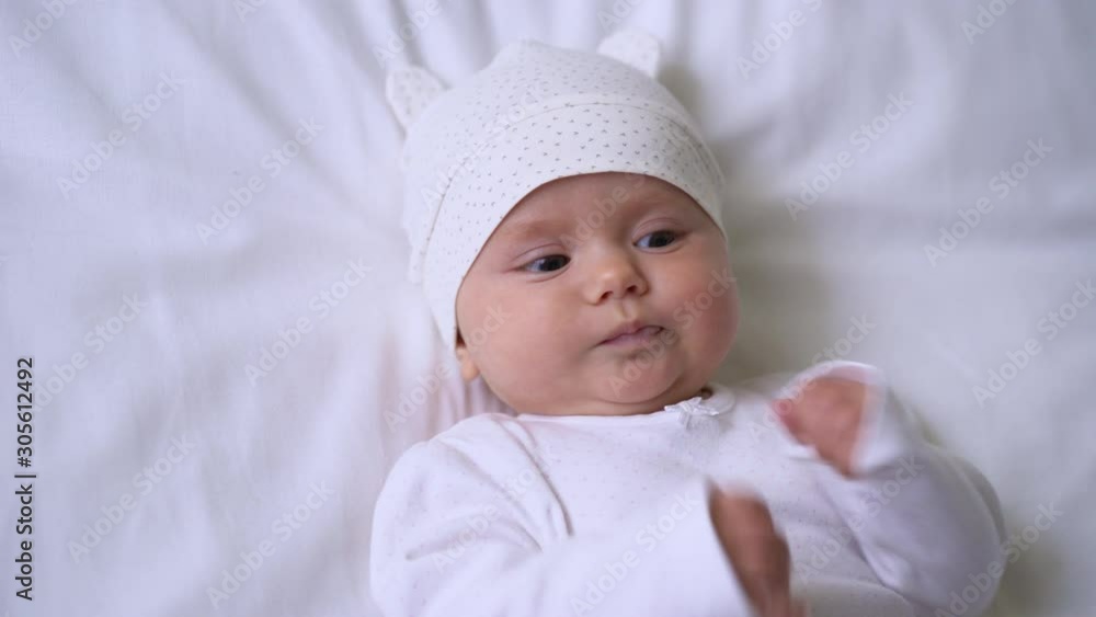 Lovely baby girl babbling and playing with sweet tiny hands, happy childhood Lovely baby girl babbling and playing with sweet tiny hands, happy childhood