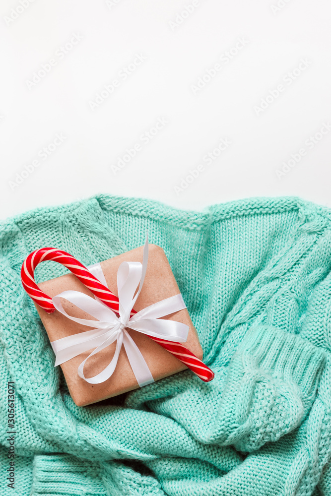 Mint Green cozy sweater with gift zero waste decorated on white background. Holiday concept Mint Green cozy sweater with gift zero waste decorated on white background. Holiday concept