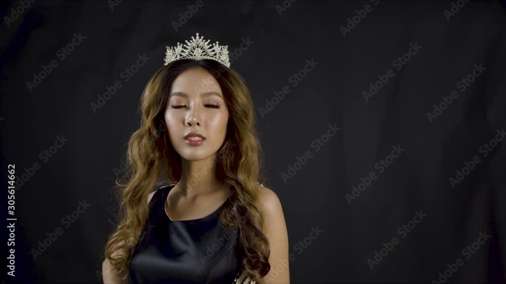 A beauty pageant winner poses for the crowd and camera while wearing her royal diamond jewel crown - copy space A beauty pageant winner poses for the crowd and camera while wearing her royal diamond jewel crown - copy space